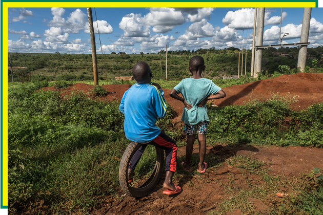 Two children look over at the sprawling Del Monte farmland