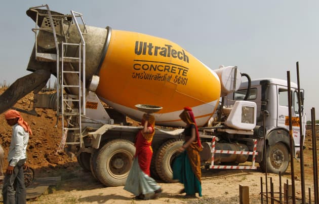 A photograph of a concrete mixer at a construction site in Ahmedabad, India