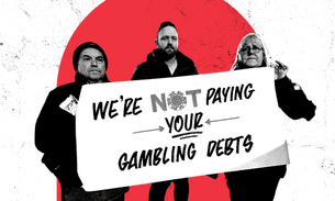 Three people hold a banner that reads: We're not paying your gambling debts