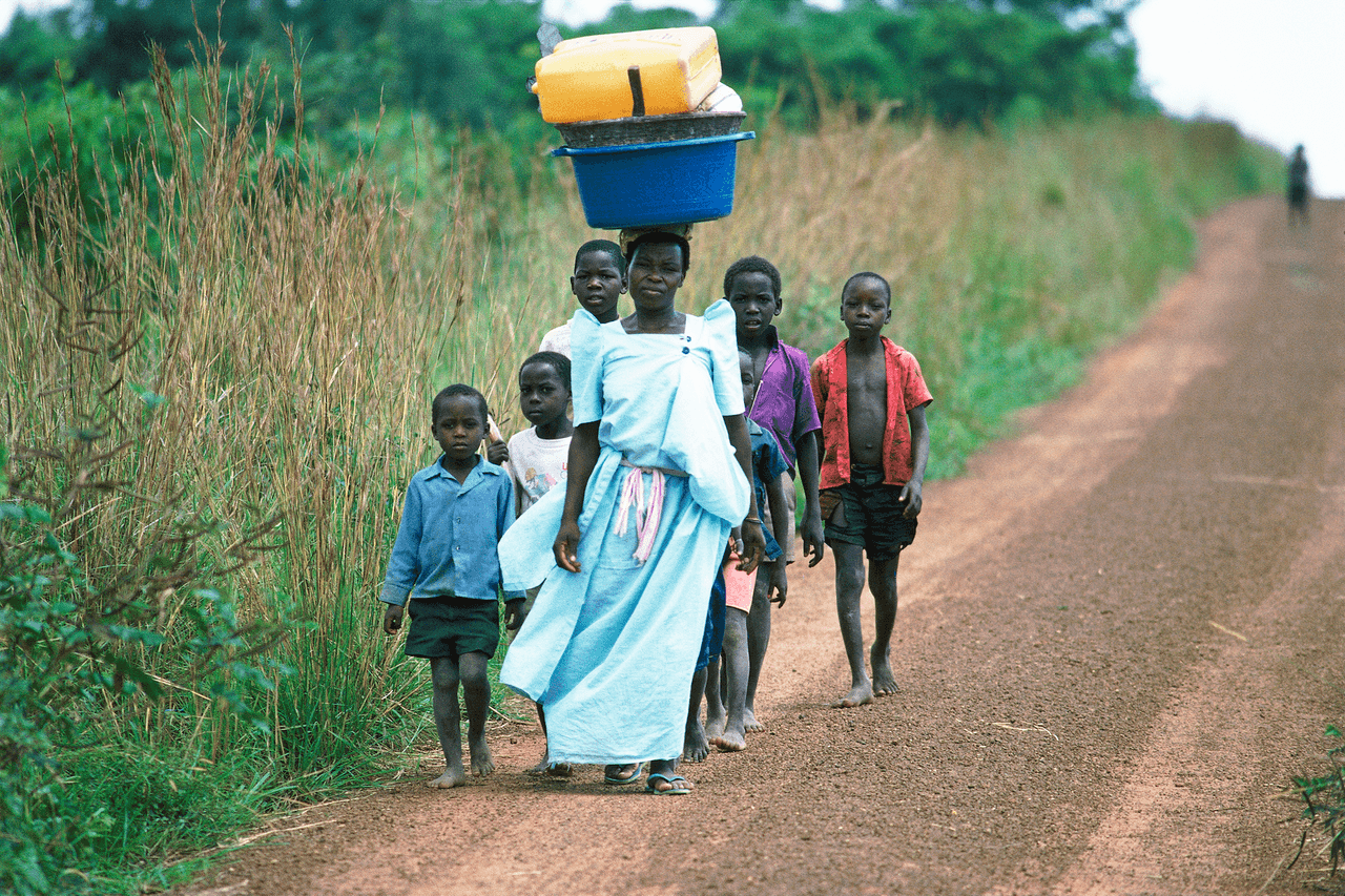 Villagers walk near Murchison Falls, Uganda