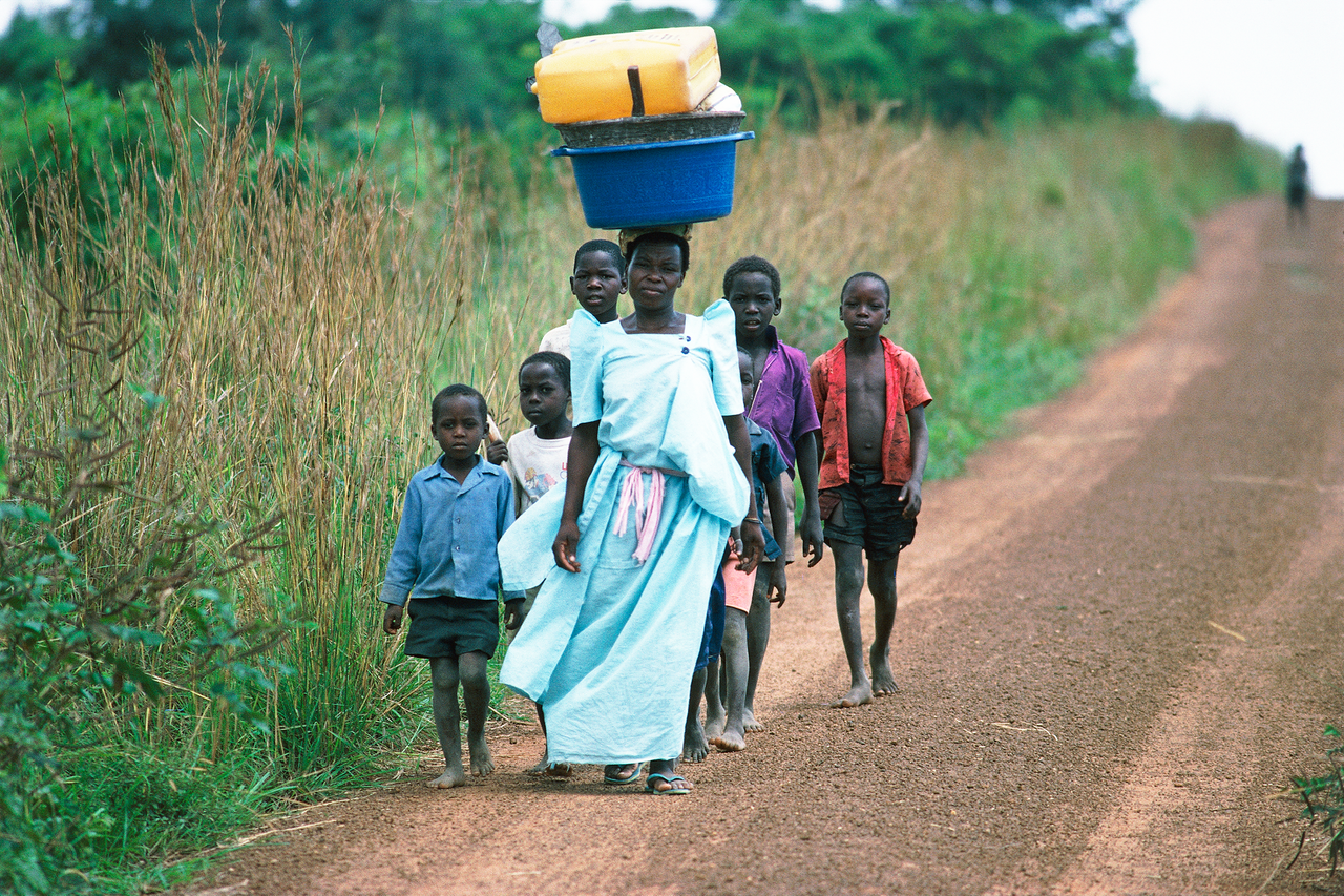 Villagers walk near Murchison Falls, Uganda