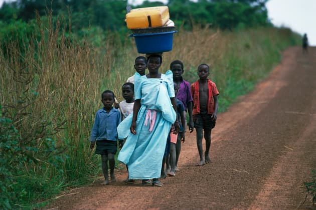 Villagers walk near Murchison Falls, Uganda