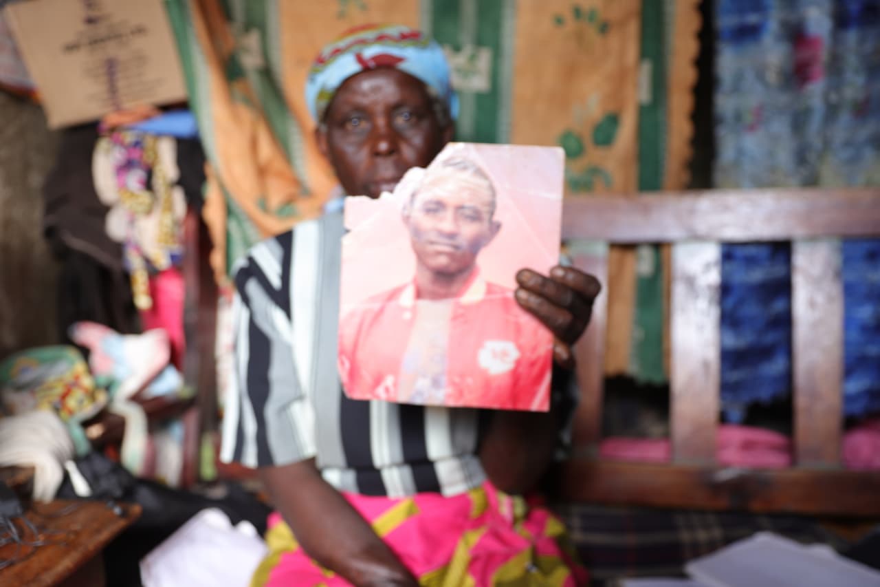 Burnice holds up a photo of her son Saidi, who died in 2013