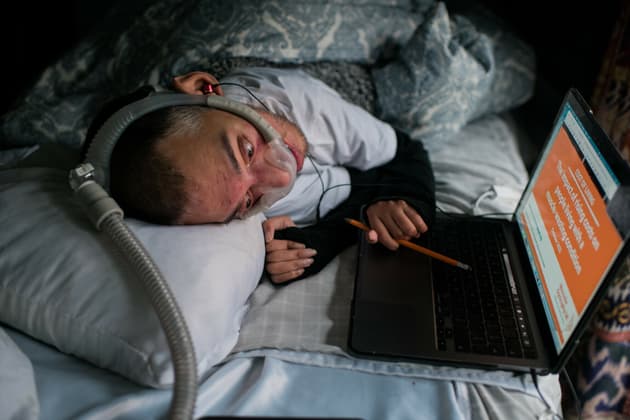 Sulaiman Khan on a computer in bed