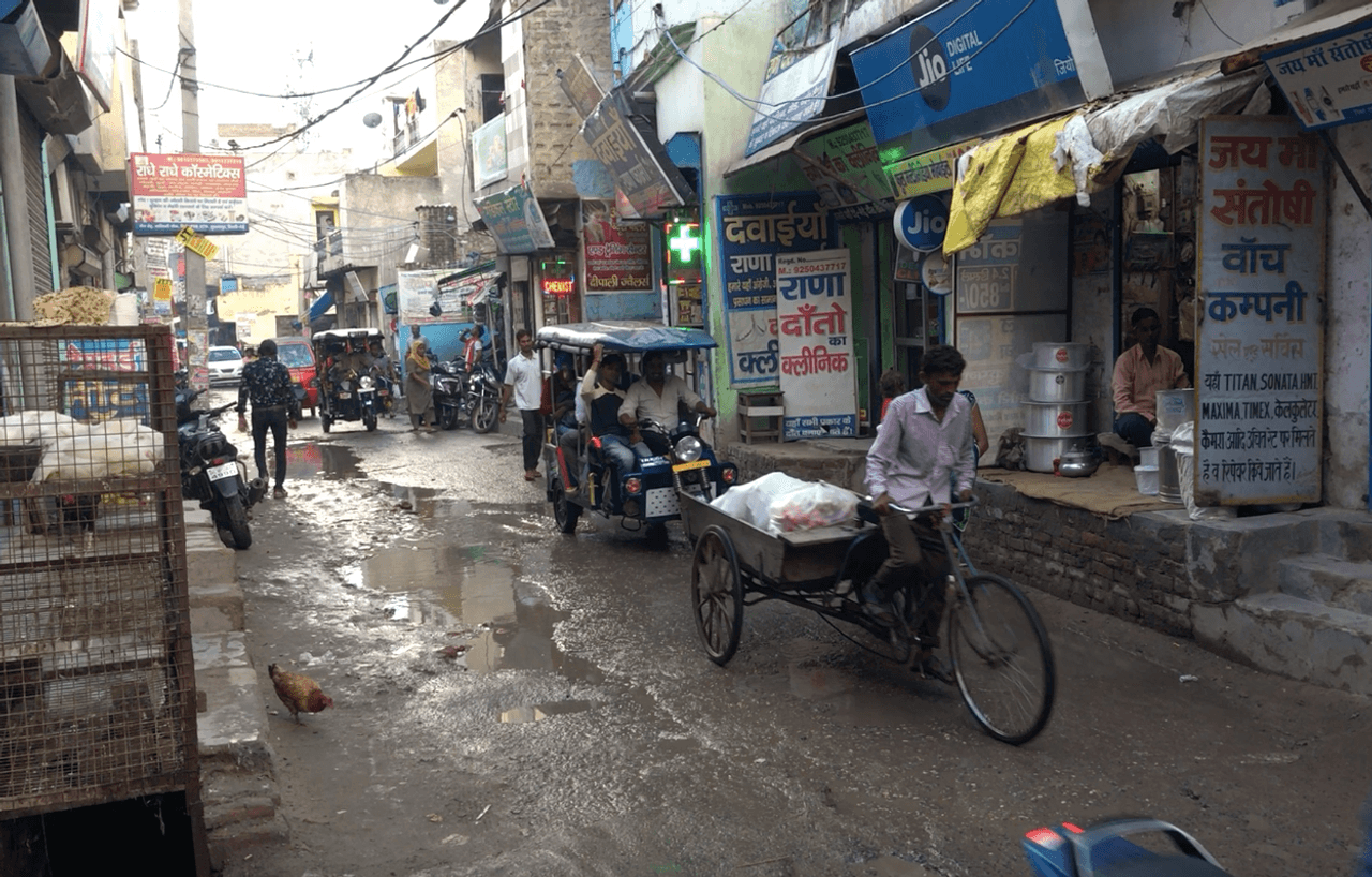A busy road in a Delhi slum