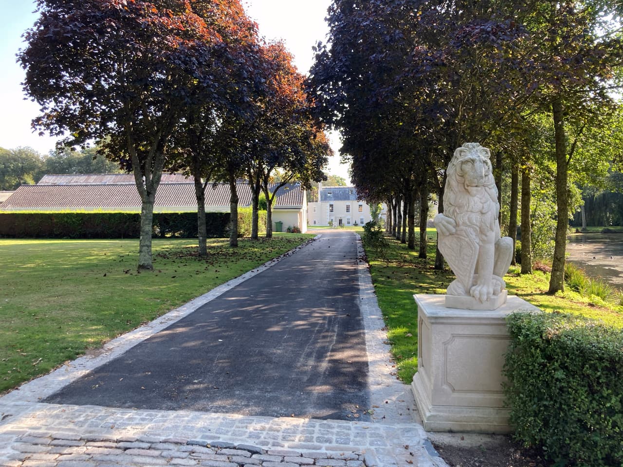 The driveway up to the manor, flanked by a lion statue
