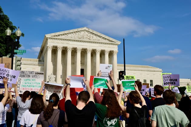 People gather outside the supreme court to protest against the repeal of Roe v Wade