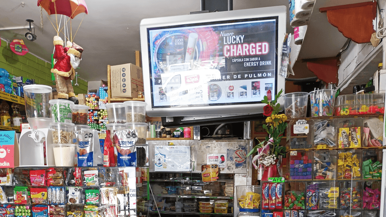 Cigarette boxes are displayed alongside sweets, chocolates and crisps in a bodega in Peru