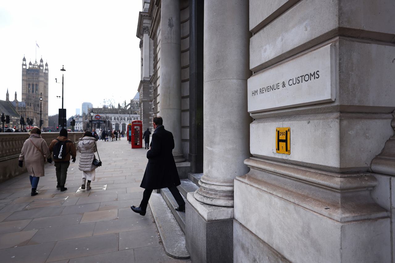 The headquarters of HM Revenue and Customs near the Houses of parliament, left, in the Westminster district of London