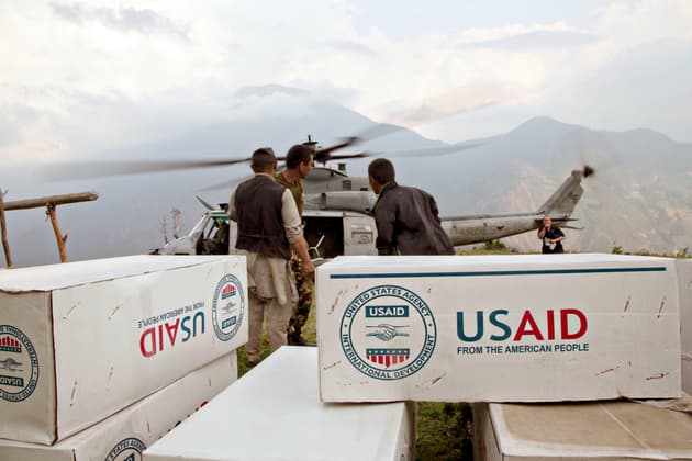 A shipment of USAID supplies is unloaded from a US Marine Corps UH-1Y Venom helicopter in a remote area of Orang, Nepal